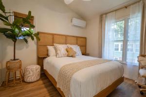 a bedroom with a bed with a cat sitting on it at Coastal Chateau Cottages in Ocean City