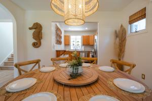 a dining room with a wooden table with plates on it at Coastal Chateau Cottages in Ocean City
