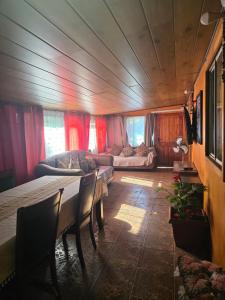 a living room with a table and a couch at Cabaña Tongariki in Hanga Roa