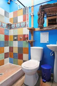 a bathroom with a toilet and a sink at Hostal La Casa De Lili in Salento +116 photos