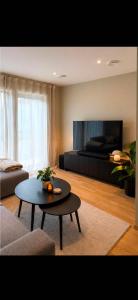a living room with a coffee table and a bed at Rekkehus i Sandnes in Stavanger