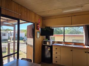 an rv kitchen with a sink and a refrigerator at Cooma Holiday Park in Cooma