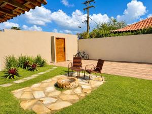 two chairs and a fire pit in a yard at BayShore Lofts in Cabo Frio