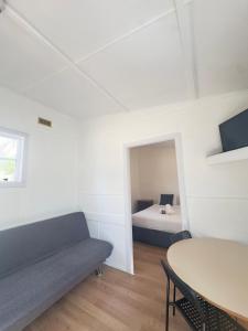a room with a couch and a bed and a table at Cooma Holiday Park in Cooma