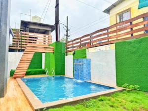 a swimming pool in the yard of a building at Sunset havan villa in Lonavala