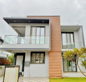 a house with a balcony on top of it at Sunset havan villa in Lonavala