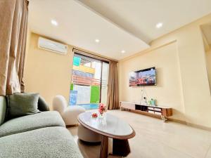 a living room with a couch and a table at Sunset havan villa in Lonavala