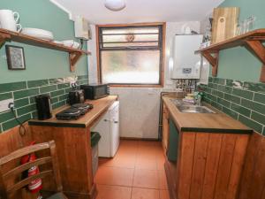 a small kitchen with a counter and a sink at Cabin No 3 - Salt and Fern Cabins in Port Talbot +19 photos