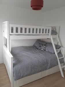 a white bunk bed in a white room at Tigh Droum in Rosscarbery