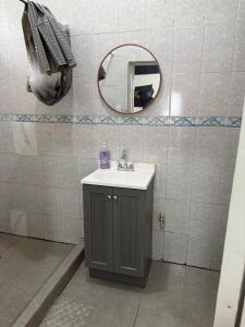 a bathroom with a sink and a mirror at Deluxe noir Loft cerca de parque fundidora in Monterrey