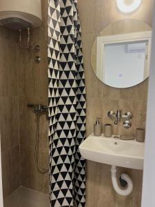 a bathroom with a sink and a shower at Navora Apartmani in Sutomore +38 photos