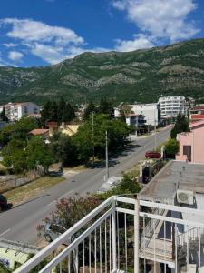 a view of a street with a mountain in the background at Navora Apartmani in Sutomore