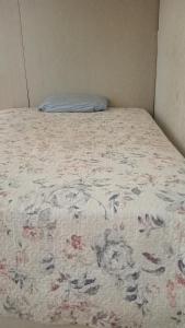 a bed in a room with a blanket on it at Jakcqueline in Pucallpa