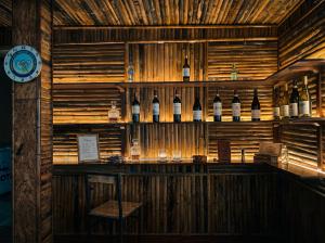 a bar with a bunch of bottles of wine at Tam Cốc FAIRY WINGS Homestay in Vũ Lâm