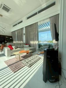 a living room with a couch and a tv at De Flourishing Hill Escape #2 in Ban Hup Kaphong