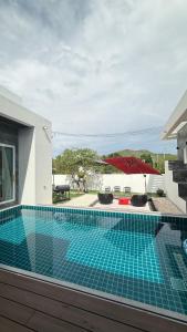 a pool with a view of a house at De Flourishing Hill Escape #2 in Ban Hup Kaphong