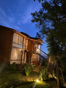 a house with stairs leading up to it at night at Suítes Ad`vinho in Lavras Novas