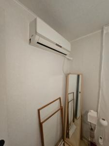 a bathroom with a ceiling fan and a mirror at STAY Humming in Seoul