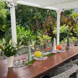 a wooden table with flowers and candles on it at Wisteria Villa in Russell
