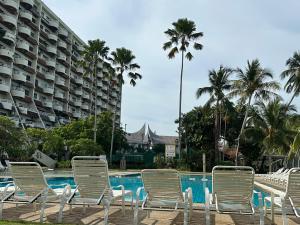 a group of lawn chairs sitting next to a swimming pool at The Regency PortDickson A1-6 in Port Dickson