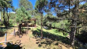 a view of a park with trees and a house at Luchita Mia Eco Cabañas Boutique in Zacatlán +48 photos