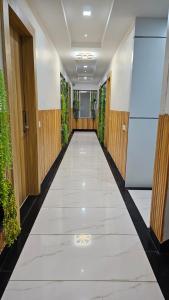 an empty corridor in a building with plants at Kanakplace in Indore +1 photo