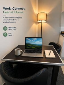 a desk with a laptop computer sitting on top of it at Quest on Queen Serviced Apartments in Auckland