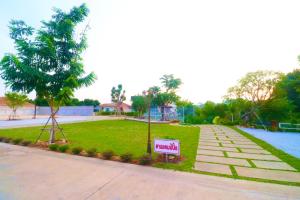 a sign in the grass next to a park at รักแรกพบรีสอร์ทสัตหีบ in Sattahip +34 photos