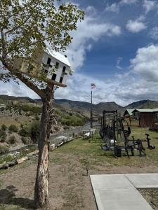 a tree with a bird house on top of it at Tiny Yellowstone Riverside Cabin in Gardiner
