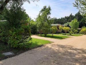 a driveway with trees and a house in the background at Chalet clim, TV - 2 pers. - API-1-52-2795 in Noves