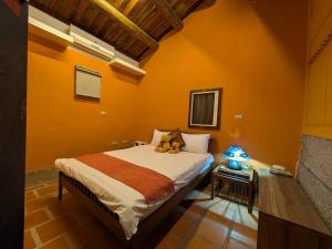 a bedroom with a bed with two teddy bears on it at PianoPiano B&B in Jincheng