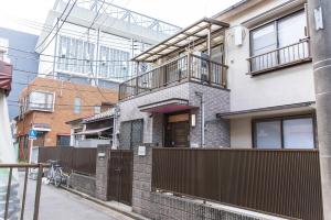 a house with a balcony on the side of it at 3 min from the station in Tokyo