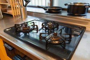 a stove top oven with two pots on top of it at 3 min from the station in Tokyo