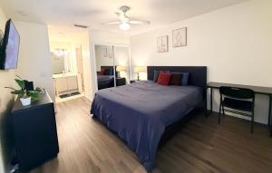 a bedroom with a bed with a blue comforter at Disney Kissimmee Condo in Kissimmee