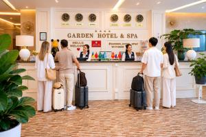 a group of people waiting at a hotel with luggage at Garden Hotel & SPA in Bishkek