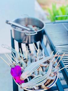 a plate of food on a grill with a flower at My Anh Garden in Ấp Thiẹn Ái