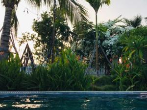 a swimming pool in a resort with a slide at My Anh Garden in Ấp Thiẹn Ái
