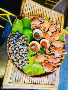a plate of food with different types of seafood at My Anh Garden in Ấp Thiẹn Ái