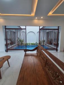 a room with a bench and a view of the water at Villa Luck Canggu Bali unit 8 in Canggu +6 photos