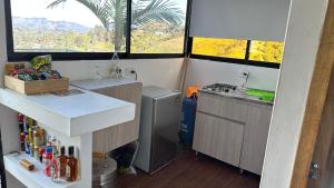 a kitchen with a sink and a stove in a room at Cabaña XAMAI in La Pradera +23 photos