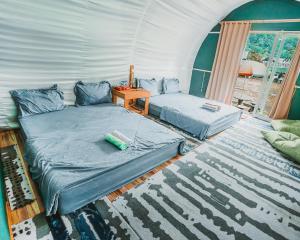 a room with two beds in a tent at Catur Glamping Bedugul in Bedugul
