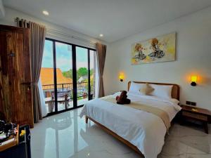 a bedroom with a bed with a teddy bear on it at Sekar Uluwatu in Uluwatu
