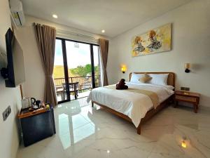 a bedroom with a bed with a stuffed animal sitting on it at Sekar Uluwatu in Uluwatu