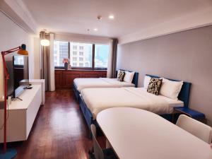 a hotel room with two beds and a television at Glocaloca gwanghwamun in Seoul +30 photos