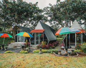 a group of tents with umbrellas in a yard at Catur Glamping Bedugul in Bedugul