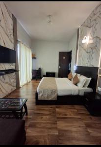 a bedroom with a large bed and a living room at krishna kunj stay in Mathura