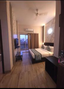 a hotel room with a bed and a balcony at krishna kunj stay in Mathura +4 photos