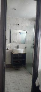a bathroom with a sink and a mirror at krishna kunj stay in Mathura