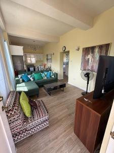 a living room with a couch and a tv at Belle Cove in Gros Islet