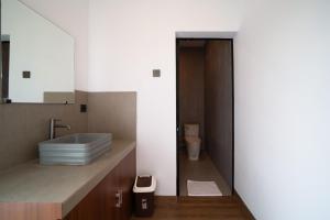 a bathroom with a sink and a toilet at Lunaire Guest House in Tabanan +32 photos